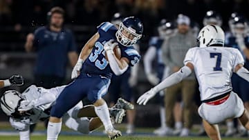 Bay Port High School's Brady Moon (33) spins away from Appleton North High School's Cole Hank (44) during a WIAA Division 1 first round playoff game on Friday, October 24, 2025, at Bay Port High School in Suamico, Wis. Bay Port won the game, 41-6.
Tork Mason/USA TODAY NETWORK-Wisconsin