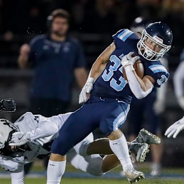 Bay Port High School's Brady Moon (33) spins away from Appleton North High School's Cole Hank (44) during a WIAA Division 1 first round playoff game on Friday, October 24, 2025, at Bay Port High School in Suamico, Wis. Bay Port won the game, 41-6.
Tork Mason/USA TODAY NETWORK-Wisconsin