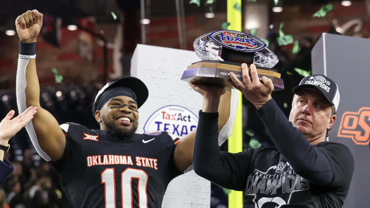 Dec 27, 2023; Houston, TX, USA; Oklahoma State Cowboys wide receiver Rashod Owens (10) and head coach Mike Gundy celebrate winning the Texas Bowl against the Texas A&M Aggies  at NRG Stadium. Mandatory Credit: Thomas Shea-USA TODAY Sports