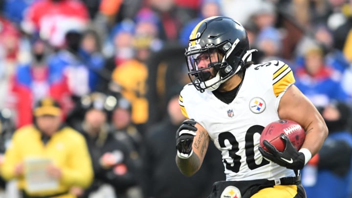 Jan 15, 2024; Orchard Park, New York, USA; Pittsburgh Steelers running back Jaylen Warren (30) runs the ball in the first half against the Buffalo Bills in a 2024 AFC wild card game at Highmark Stadium. Mandatory Credit: Mark Konezny-USA TODAY Sports