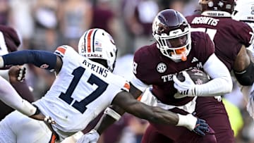 Sep 27, 2025; College Station, Texas, USA; Texas A&M Aggies running back Le'Veon Moss (8) runs the ball as Auburn Tigers linebacker Xavier Atkins (17) lunges for the tackle during the third quarter at Kyle Field. Mandatory Credit: Maria Lysaker-Imagn Images 