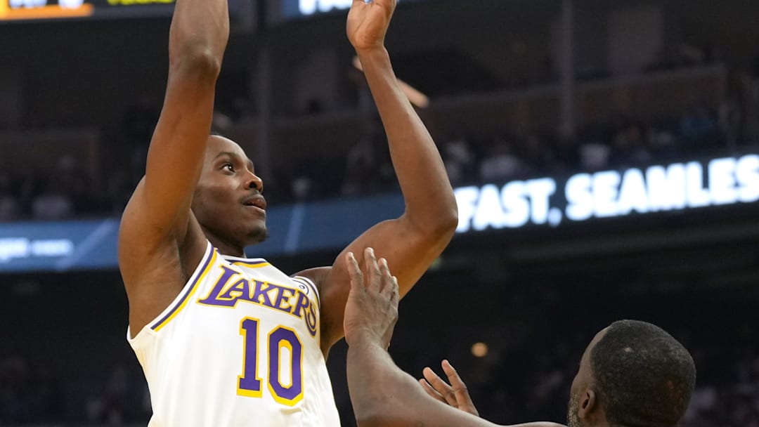 Dec 25, 2024; San Francisco, California, USA; Los Angeles Lakers center Christian Koloko (10) shoots against Golden State Warriors forward Draymond Green (23) during the second quarter at Chase Center. Mandatory Credit: Darren Yamashita-Imagn Images
