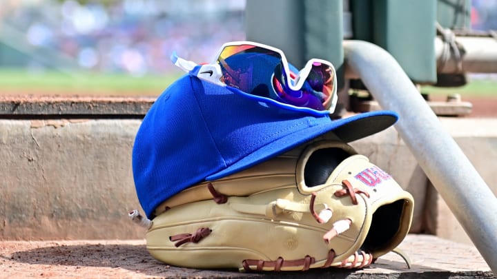 Feb 27, 2024; Mesa, Arizona, USA;  General view of a Chicago Cubs glove, hat and glasses in the first inning against the Cincinnati Reds during a spring training game at Sloan Park. Mandatory Credit: Matt Kartozian-USA TODAY Sports