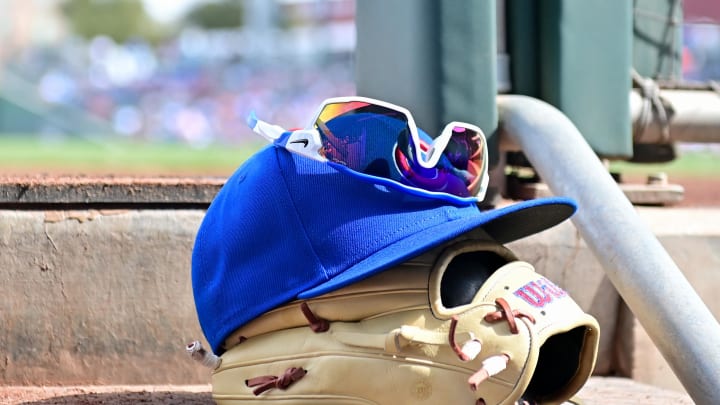 Feb 27, 2024; Mesa, Arizona, USA;  General view of a Chicago Cubs glove, hat and glasses in the first inning against the Cincinnati Reds during a spring training game at Sloan Park. Mandatory Credit: Matt Kartozian-USA TODAY Sports