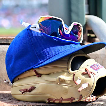 Feb 27, 2024; Mesa, Arizona, USA;  General view of a Chicago Cubs glove, hat and glasses in the first inning against the Cincinnati Reds during a spring training game at Sloan Park. Mandatory Credit: Matt Kartozian-Imagn Images