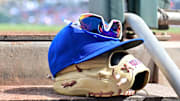 Feb 27, 2024; Mesa, Arizona, USA;  General view of a Chicago Cubs glove, hat and glasses in the first inning against the Cincinnati Reds during a spring training game at Sloan Park. Mandatory Credit: Matt Kartozian-Imagn Images