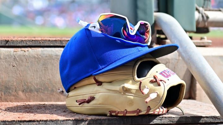 Feb 27, 2024; Mesa, Arizona, USA;  General view of a Chicago Cubs glove, hat and glasses in the first inning against the Cincinnati Reds during a spring training game at Sloan Park. Mandatory Credit: Matt Kartozian-USA TODAY Sports