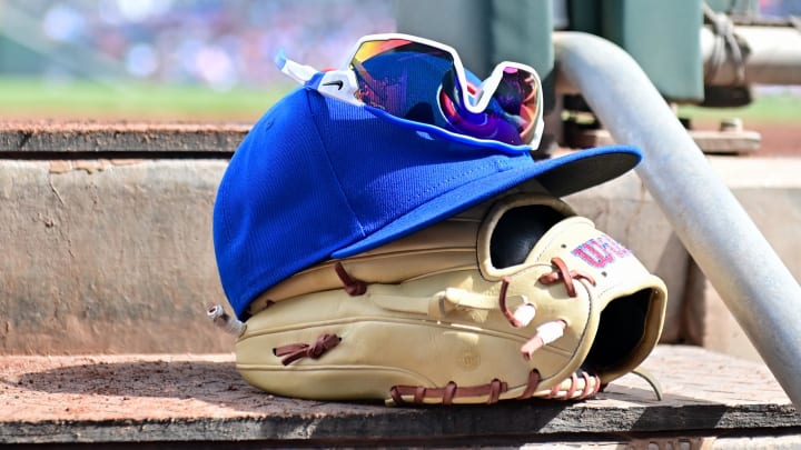 Feb 27, 2024; Mesa, Arizona, USA;  General view of a Chicago Cubs glove, hat and glasses.