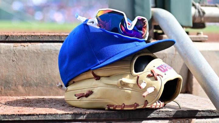 A Chicago Cubs glove, hat and glasses