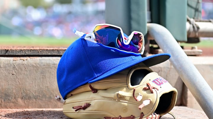 Feb 27, 2024; Mesa, Arizona, USA;  General view of a Chicago Cubs glove, hat and glasses in the first inning against the Cincinnati Reds during a spring training game at Sloan Park. Mandatory Credit: Matt Kartozian-Imagn Images