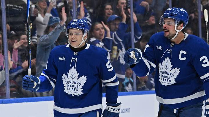 Oct 25, 2025; Toronto, Ontario, CAN; Toronto Maple Leafs left Wing Nicholas Robertson (89) (obscured) celebrates with right wing Easton Cowan (53) and  center Auston Matthews (34) after scoring a goal against the Buffalo Sabres in the first period at Scotiabank Arena. Mandatory Credit: Gerry Angus-Imagn Images