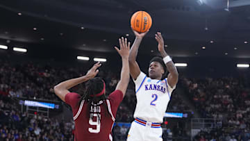 Mar 20, 2025; Providence, RI, USA;  Kansas Jayhawks guard AJ Storr (2) shoots the ball against Arkansas Razorbacks forward Jonas Aidoo (9) during the second half at Amica Mutual Pavilion. Mandatory Credit: Gregory Fisher-Imagn Images