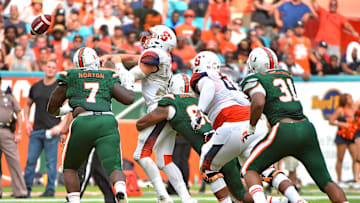 Oct 21, 2017; Miami Gardens, FL, USA; Miami Hurricanes defensive lineman RJ McIntosh (80) hits Syracuse Orange quarterback Eric Dungey (2) during the first half at Hard Rock Stadium. Mandatory Credit: Jasen Vinlove-Imagn Images