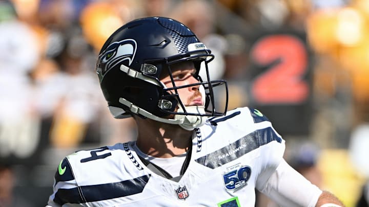 Seattle Seahawks quarterback Sam Darnold throws while being pressured by Pittsburgh Steelers defensive tackle Keeanu Benton