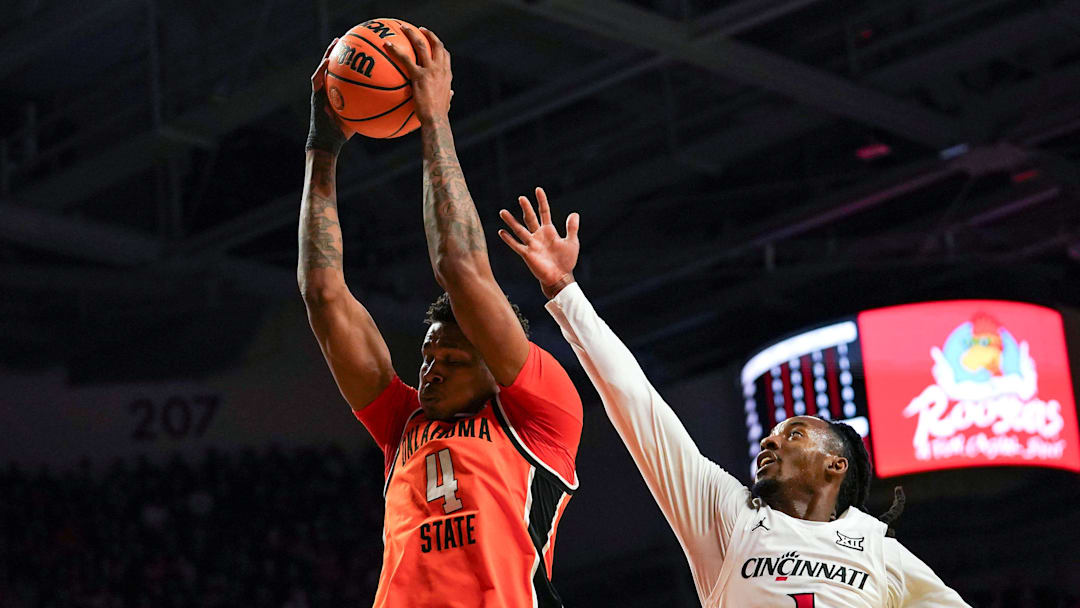 Oklahoma State Cowboys guard Christian Coleman (4) rebounds the ball in the first half of a NCAA men’s basketball game between the Cincinnati Bearcats and Oklahoma State Cowboys, Saturday, Feb. 28, 2026, at Fifth Third Arena in Cincinnati.