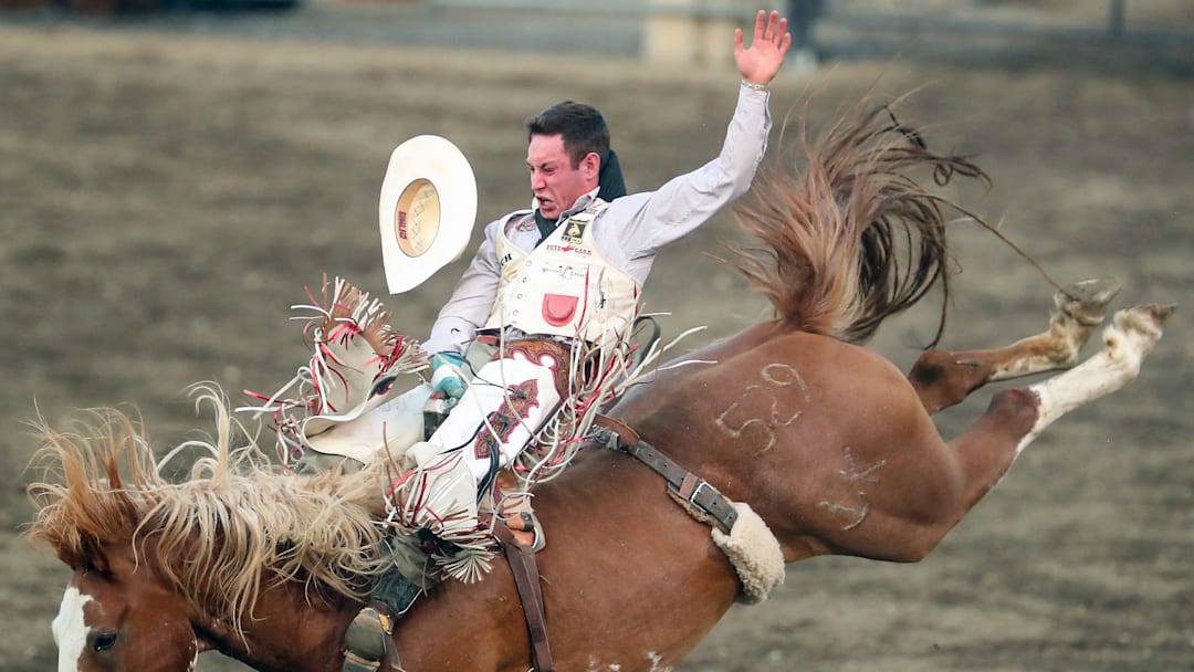 Bareback rider Cole Franks, of Clarendon, Texas, loses his hat as he rides a bucking horse named Dixie   s Gravy dragon the rodeo at the Kitsap Fair & Stampede on Friday, Aug. 25, 2023.