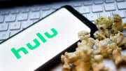 In this photo illustration a Hulu logo seen displayed on a...