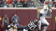 Oct 28, 2023; Minneapolis, Minnesota, USA; Michigan State Spartans running back Nate Carter (5) breaks the tackle of Minnesota Golden Gophers defensive back Jack Henderson (20) during the first quarter at Huntington Bank Stadium. Mandatory Credit: Nick Wosika-USA TODAY Sports