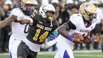 Alabama State defense back Adrian Maddox wraps up Alcorn quarterback Aaron Allen (4) during their game at Hornet Stadium in Montgomery, Ala., on Saturday September 30, 2023.