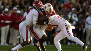 Auburn Tigers wide receiver Kobe Hudson (5) drops a pass against Alabama defensive back DeMarcco Hellams (2) and linebacker Henry To'o To'o (10) during the Iron Bowl at Jordan-Hare Stadium in Auburn, Ala., on Saturday, Nov. 27, 2021.

Ncaa Football Alabamaat Auburn