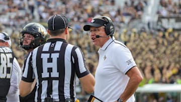 Nov 25, 2023; Orlando, Florida, USA; UCF Knights head coach Gus Malzahn talks to Head Linesman Any Warner during a play review in the first quarter against the Houston Cougars at FBC Mortgage Stadium. Mandatory Credit: Mike Watters-Imagn Images