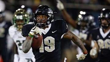 Nov 24, 2017; Orlando, FL, USA; UCF Knights kick returner Mike Hughes (19) runs back the kick 94 yards for the go ahead scorer against the South Florida Bulls during the second half at Spectrum Stadium. Mandatory Credit: Reinhold Matay-Imagn Images