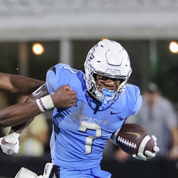 Nov 11, 2023; Orlando, Florida, USA; UCF Knights running back RJ Harvey (7) runs the ball against Oklahoma State Cowboys safety Trey Rucker (9) during the second half at FBC Mortgage Stadium. Mandatory Credit: Mike Watters-Imagn Images