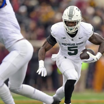 Oct 28, 2023; Minneapolis, Minnesota, USA; Michigan State Spartans running back Nate Carter (5) runs with the ball against the Minnesota Golden Gophers during the first quarter at Huntington Bank Stadium. Mandatory Credit: Nick Wosika-USA TODAY Sports