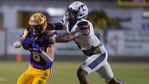 Charles Henderson's Zion Grady (6) stops Tallassee's Cade Everson in 2022. Grady is now at Enterprise (Alabama).