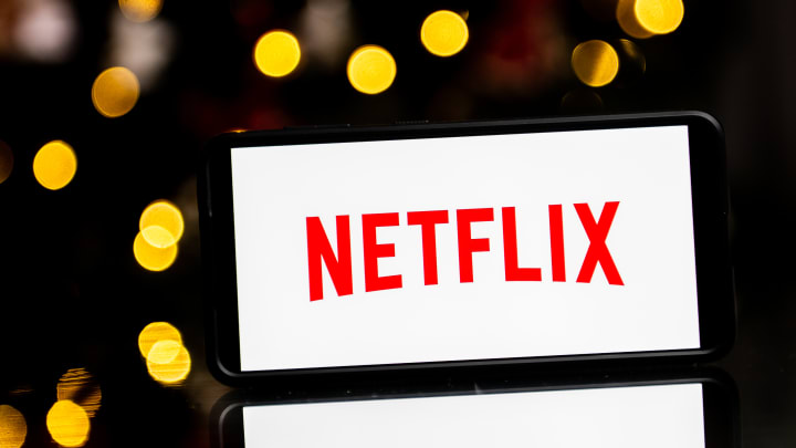 In this photo illustration a Netflix logo seen displayed on...