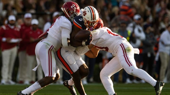 Auburn Tigers wide receiver Kobe Hudson (5) drops a pass against Alabama defensive back DeMarcco Hellams (2) and linebacker Henry To'o To'o (10) during the Iron Bowl at Jordan-Hare Stadium in Auburn, Ala., on Saturday, Nov. 27, 2021.

Ncaa Football Alabamaat Auburn