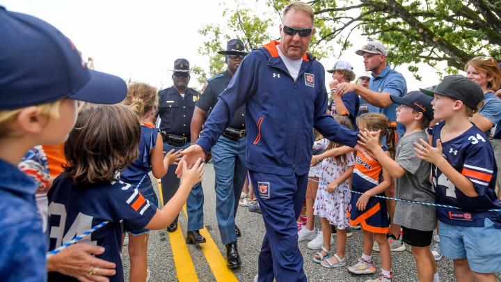 Auburn Tigers head coach Hugh Freeze greets young fans during the Tiger Walk before the AU vs.
