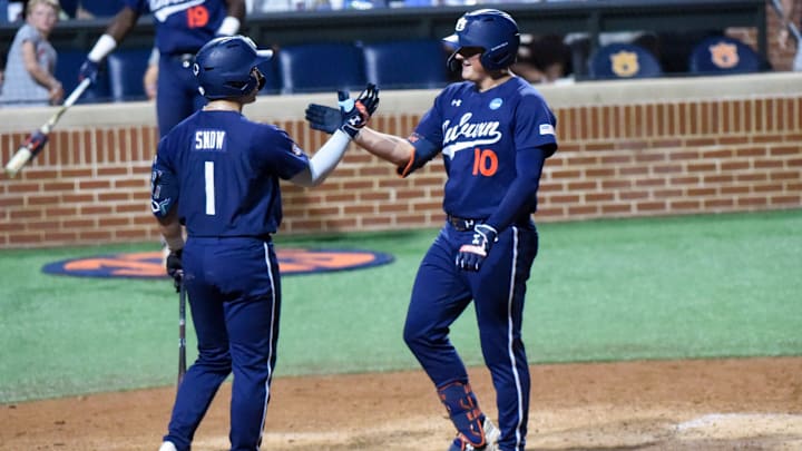 Auburn Tigers' Lucas Steele (10) is greeted at home by Auburn Tigers' Eric Snow (1) after hitting a home run against the Central Connecticut State Blue Devils during the NCAA Regional Baseball Tournament at Plainsman Park in Auburn, Ala., on Friday May 30, 2025.
