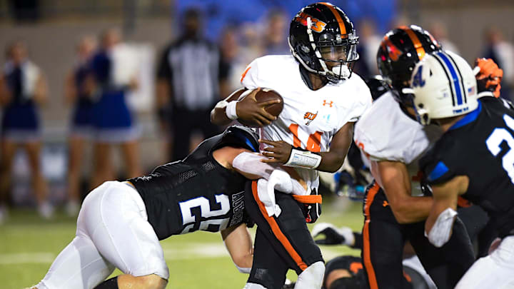 Hoover   s Jonah Winston (14) is stopped by Auburn High School's Camauri Russell (25) during their game at Cramton Bowl in Montgomery, Ala., on Friday evening August 19, 2022.

Ah37