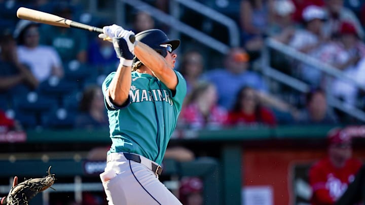 Seattle Mariners outfielder Jonny Farmelo (98) looks out to the field after hitting a RBI single in the ninth inning of a Cactus League game between the Cincinnati Reds and Seattle Mariners, Sunday, Feb. 22, 2026, at Goodyear Ballpark in Goodyear, Ariz. Mariners won 14-8.