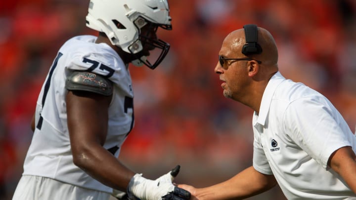 Penn State Nittany Lions head coach James Franklin shakes hands with offensive lineman Sal Wormley.