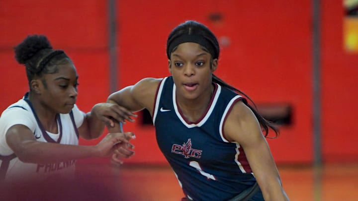 Park Crossing's Saniya Jackson (1) drives against Percy Julian's Bilqis Brenson (0) during their game at the Percy Julian campus in Montgomery, Ala., on Saturday January 4, 2025.