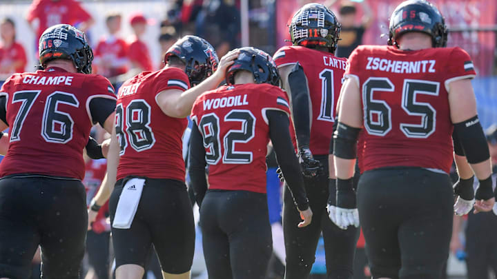 Northern Illinois Huskies kicker Kanon Woodill (92) is consoled after hitting the goalpost and missing a field goal for the second time against the Arkansas State Red Wolves in the Camellia Bowl at Cramton Bowl in Montgomery, Ala., on Saturday December 23, 2023.