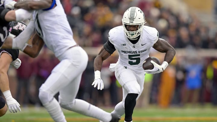 Oct 28, 2023; Minneapolis, Minnesota, USA; Michigan State Spartans running back Nate Carter (5) runs with the ball against the Minnesota Golden Gophers during the first quarter at Huntington Bank Stadium. Mandatory Credit: Nick Wosika-Imagn Images