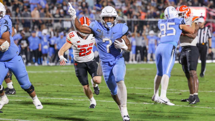 Nov 11, 2023; Orlando, Florida, USA; UCF Knights running back RJ Harvey (7) carries the ball for a touchdown during the second half against the Oklahoma State Cowboys at FBC Mortgage Stadium. Mandatory Credit: Mike Watters-USA TODAY Sports