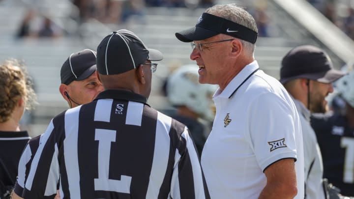 Oct 28, 2023; Orlando, Florida, USA; UCF Knights head coach Gus Malzahn talks with officials before the game against the West Virginia Mountaineers at FBC Mortgage Stadium. Mandatory Credit: Mike Watters-USA TODAY Sports