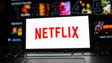 In this photo illustration a Netflix logo seen displayed on...
