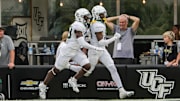 Sep 30, 2023; Orlando, Florida, USA; Baylor Bears cornerback Caden Jenkins (19) celebrates his touchdown with a teammate during the second half against the UCF Knights at FBC Mortgage Stadium. Mandatory Credit: Mike Watters-Imagn Images