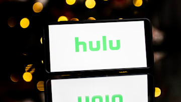 In this photo illustration a Hulu logo seen displayed on a...