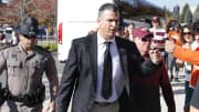 Oct 15, 2022; Blacksburg, Virginia, USA;  Miami Hurricanes head coach Mario Cristobal (center) greets fans as he gets off of the team bus before the game against the Virginia Tech Hokies at Lane Stadium. Mandatory Credit: Reinhold Matay-USA TODAY Sports