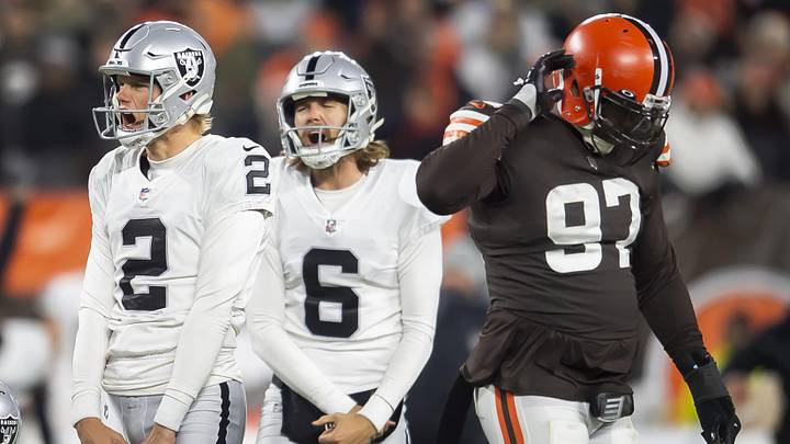 Dec 20, 2021; Cleveland, Ohio, USA; Las Vegas Raiders kicker Daniel Carlson (2) and holder A.J. Cole (6) celebrate after Carlson kicked the game-winning field goal as Cleveland Browns defensive tackle Malik Jackson (97) walks off the field during the fourth quarter at FirstEnergy Stadium.