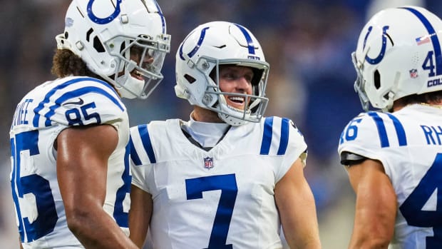 Indianapolis Colts kicker Matt Gay (all-white uniform w/blue trim) celebrates after a field goal with his teammates. 