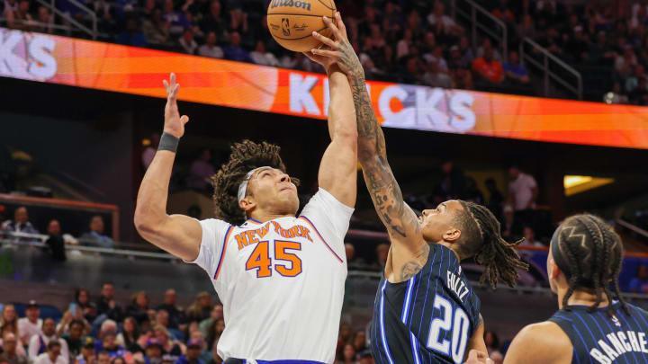 Feb 7, 2023; Orlando, Florida, USA; New York Knicks center Jericho Sims (45) and Orlando Magic guard Markelle Fultz (20) battle for the rebound during the first quarter at Amway Center. Mandatory Credit: Mike Watters-USA TODAY Sports