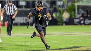 Nov 29, 2024; Orlando, Florida, USA; UCF Knights running back RJ Harvey (7) runs the ball during the second quarter against the Utah Utes at FBC Mortgage Stadium. Mandatory Credit: Mike Watters-Imagn Images