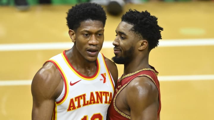 Nov 28, 2023; Cleveland, Ohio, USA; Cleveland Cavaliers guard Donovan Mitchell (45) reacts beside Atlanta Hawks forward De'Andre Hunter (12) in the fourth quarter at Rocket Mortgage FieldHouse. Mandatory Credit: David Richard-USA TODAY Sports